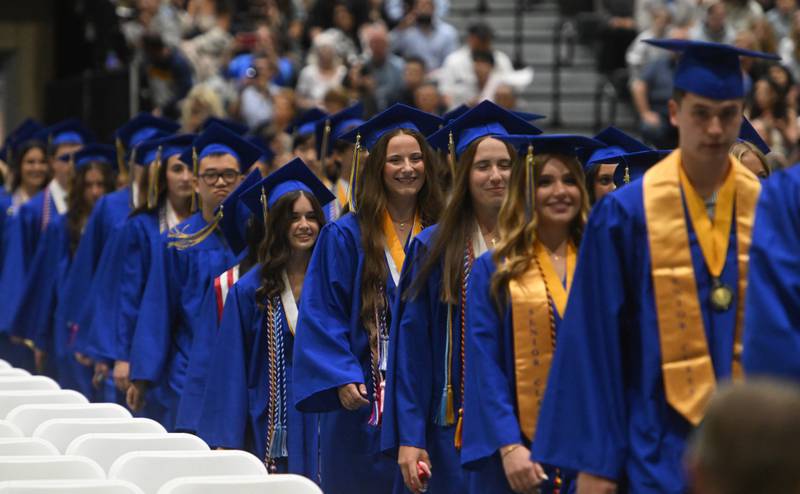 Wheaton North graduates walk to "Pomp and Circumstance" during the school's commencement ceremony on Saturday, May 24, 2025 at College of DuPage in Glen Ellyn.