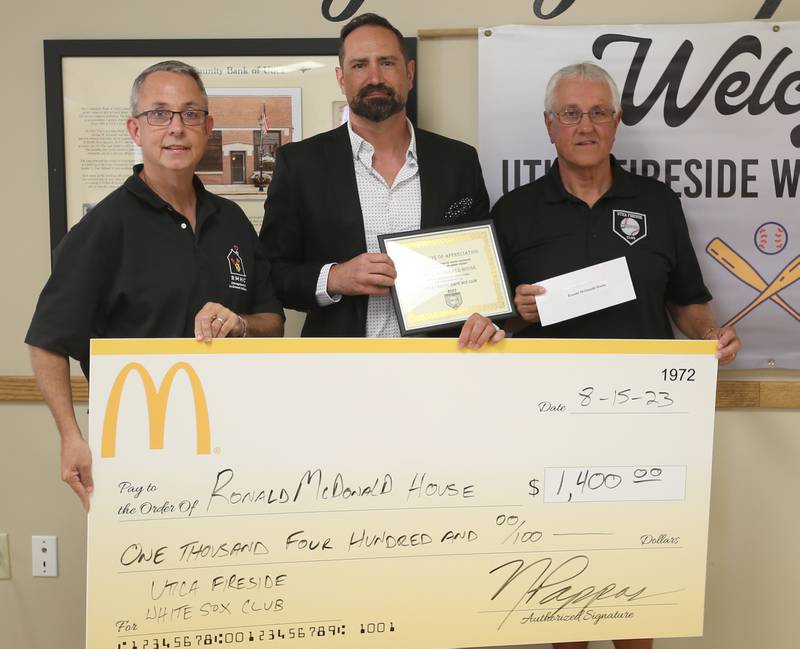 Utica Fireside White Sox Club members Jack Gichooly, and Randy Tuftie hands Nathan Pappas a $1,400 check donation during the 14th annual Utica Fireside White Sox Club donation presentation on Tuesday, Aug. 15, 2023 at the Utica Township Community Building. Pappas owns local several McDonalds franchises throughout the Illinois Valley.
