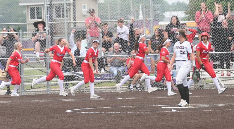 Members of the Bradley-Bourbonnais softball team race to hoome plate after teammate Suttyn Hop blasts a home run during the Class 4A Supersectional game on Friday, June 6, 2025 at Monticello High School.