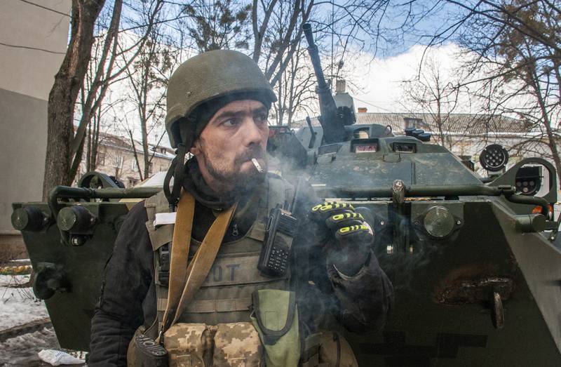A volunteer of the Ukrainian Territorial Defense Forces stands next to his APC in Kharkiv, Ukraine, Wednesday, March 16, 2022. NATO Secretary-General Jens Stoltenberg made it clear Tuesday that the 30-nation military alliance is set to radically change its security stance in Europe in response to Russia's war on Ukraine. (AP Photo/Andrew Marienko)