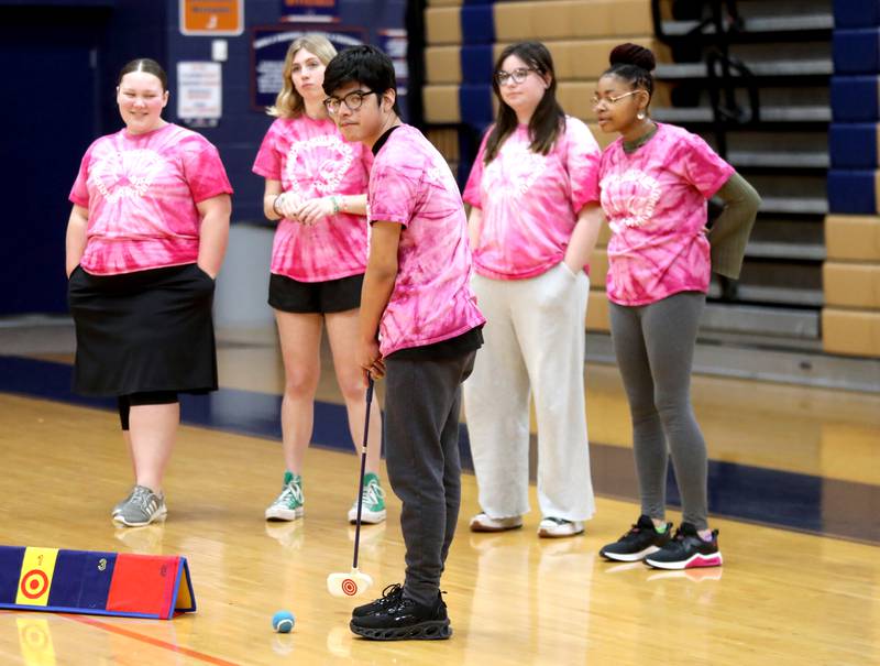 Oswego High School student Omar Lopez prepares to hit the golf ball during a physical education class at Oswego High School on Monday, March 4, 2024. The class was part of a six-week program collaboration with the U.S. Adaptive Golf Alliance.