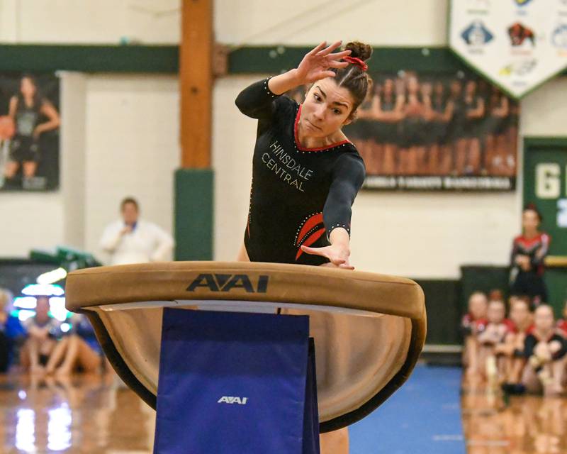 A Hinsdale Central gymnast competes on the vault during the conference meet held at Glenbard West on Saturday Jan. 27, 2024.