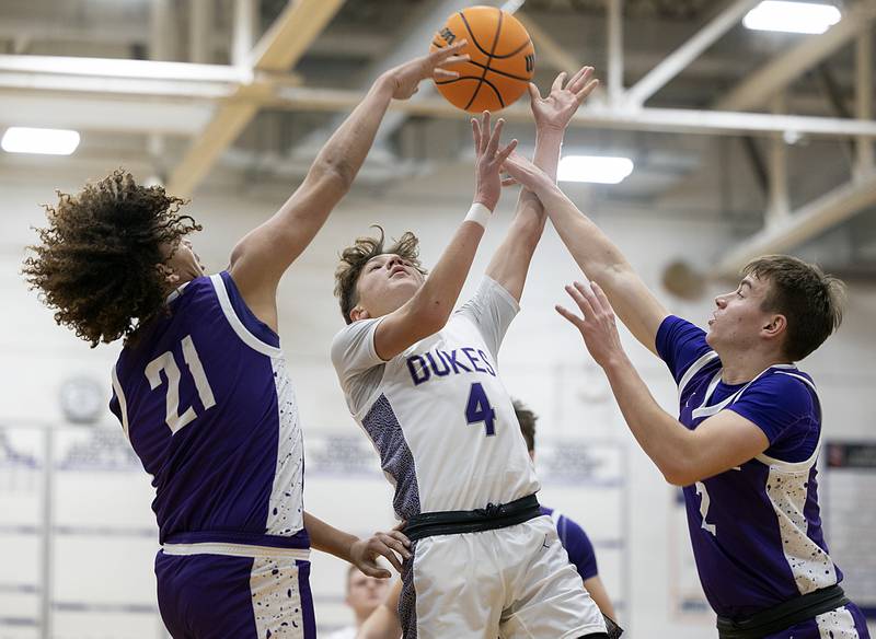 Dixon’s Brody Nicklaus has the ball knocked away by Rochelle’s Van Gerber (right) Monday, Dec. 9, 2024, at Dixon High School.