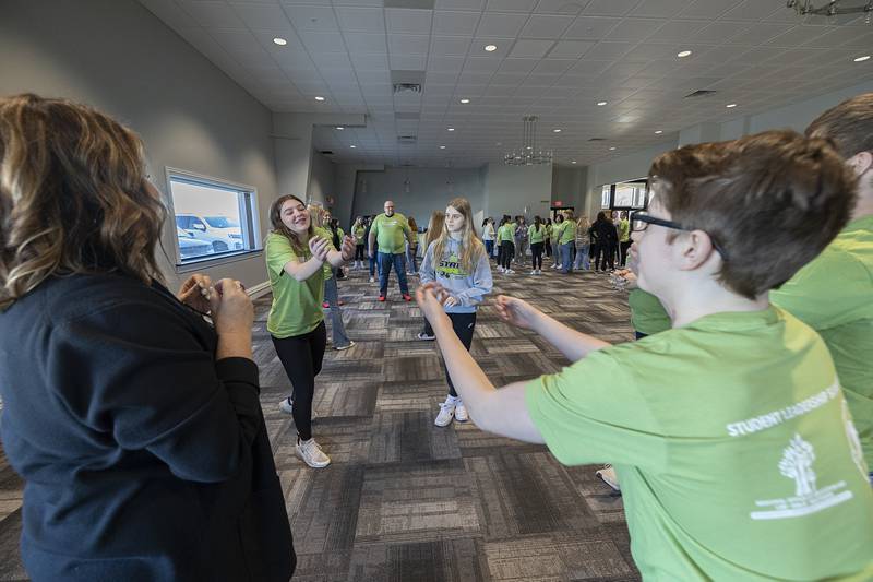 Amboy students toss an imaginary ball as a practice of retaining information Friday, March 15, 2024 during a student leadership summit featuring speaker Dr. Alonzo Kelly.
