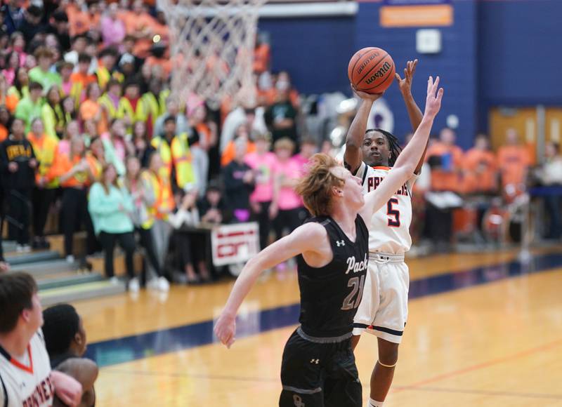 Oswego’s Tyrell Mays (5) shoots a jumper over Oswego East's Andrew Pohlman (21) during a basketball game at Oswego High School on Tuesday, Dec 12, 2023.