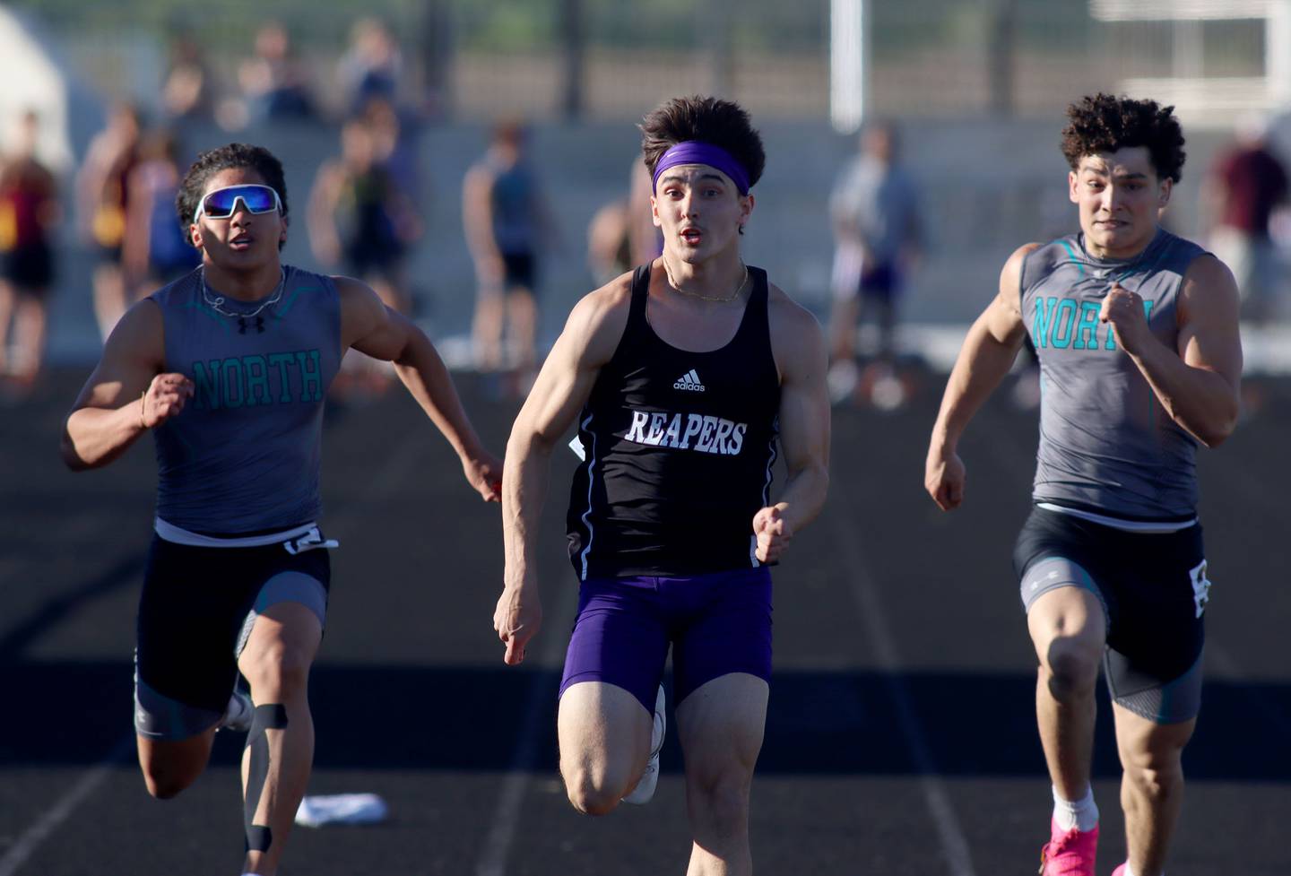 Plano’s Tristan Meszaros, center,  competes in the 100-meter dash in KRC Conference Track Meet action at Richmond-Burton High School in Richmond on Tuesday, May 13, 2025. At left is Woodstock North’s Jovan Suay and at right is Woodstock’s George Kingos.