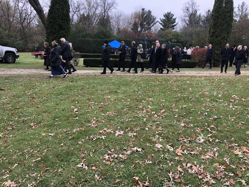 Mourners depart the burial service for Herb Franks Friday.