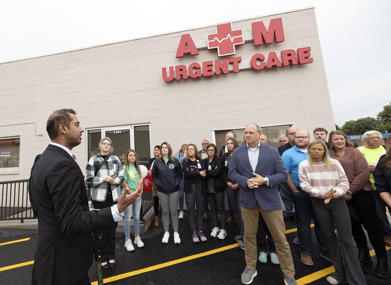 Dr. Ashok Maini gestures Friday while thanking all those who helped him open the new A.M. Urgent Care facility in Rock Falls.