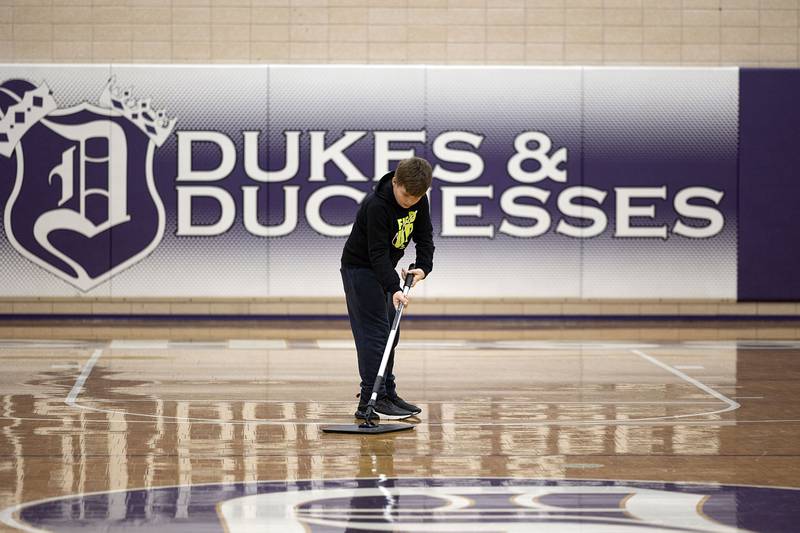 A young man gets to work cleaning the basketball court in Dixon Thursday, Jan. 26, 2023.