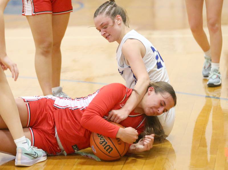 Hall's Kennedy Wozniak dives for the ball as Princeton's Keighley Davis arrives late to the play during the Princeton Holiday Girls Basketball Tournament on Friday, Nov. 23, 2024 at Princeton High School.