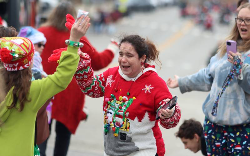 Maryann Racz of McHenry embraces her daughter Alexis, 11, during the Toys for Tots Parade on Sunday, Nov. 24, 2024, in downtown McHenry.