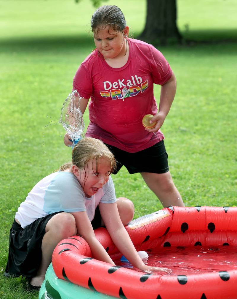 Kate Fowler, (left) 11, from DeKalb, gets splashed by Leila Thompson, 7, from DeKalb, during the Pride Palooza Friday, May 30, 2025, at Bethlehem Lutheran Church in DeKalb. The event was hosted by Family Service Agency of DeKalb County and Youth Outlook.