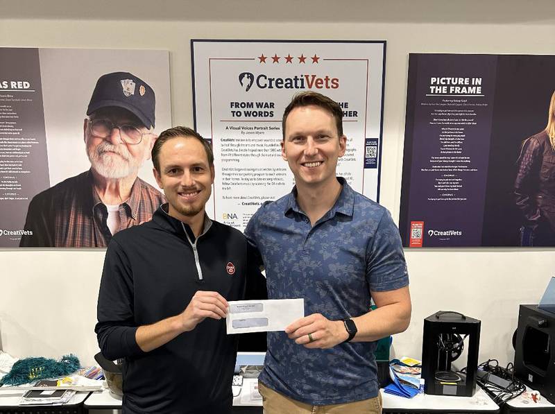 Drew Herridge, fair board director and concert chairman, presents a $3,000 check to co-founder of CreatiVets, Richard Casper.