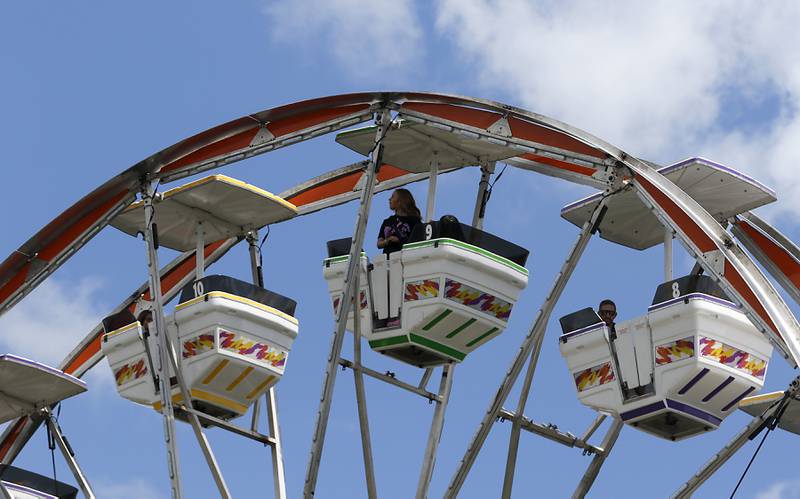 A girl looks out over the festival while riding the Ferris wheel during Lakeside Festival on Friday, July 5, 2024, at the Dole.