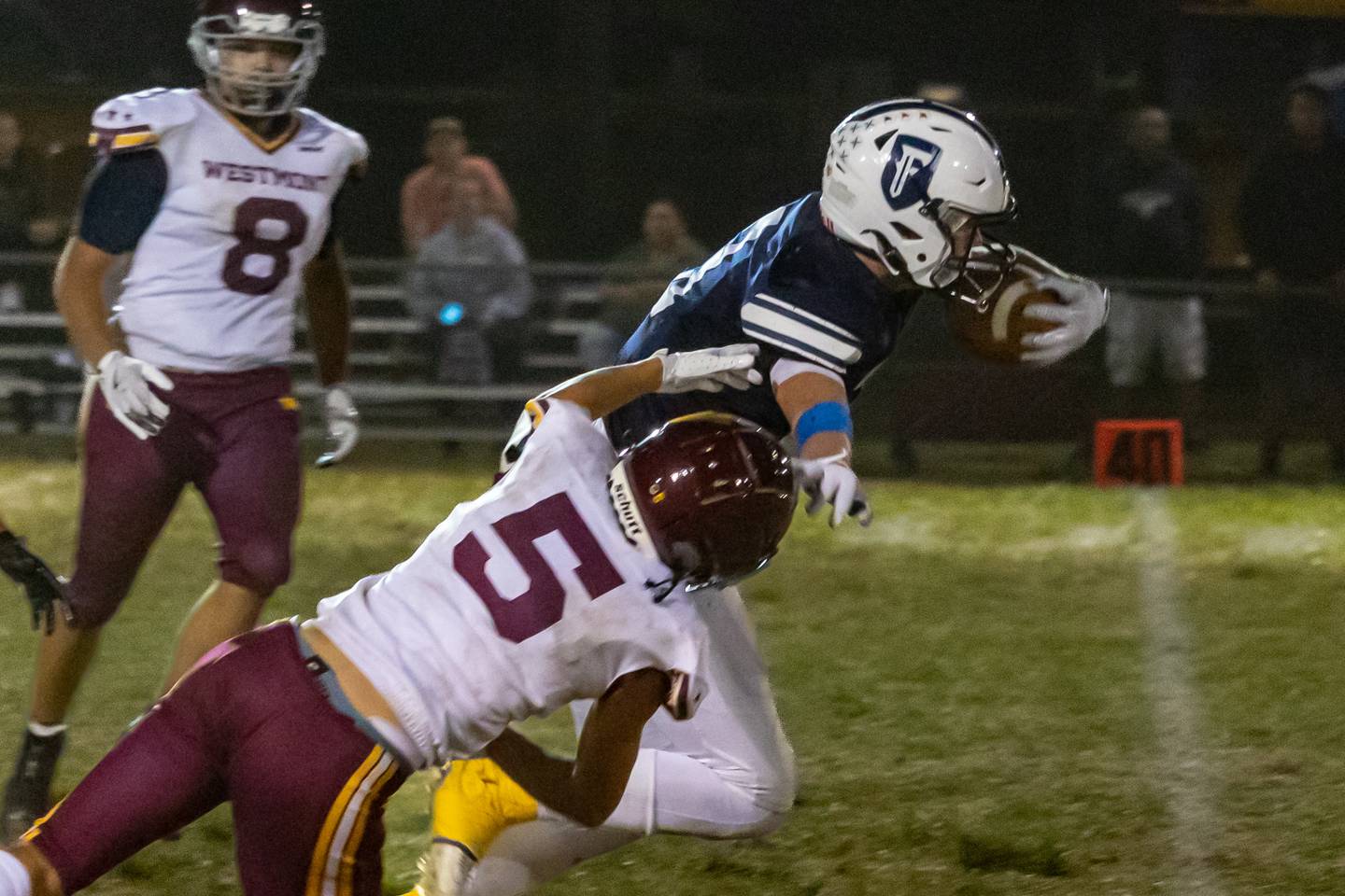 Eddie Lorton of Fieldcrest runs ball whilst being tackled by Sean Patterson of Westmont on Friday, September 20, 2024 at Fieldcrest high school in Minonk.