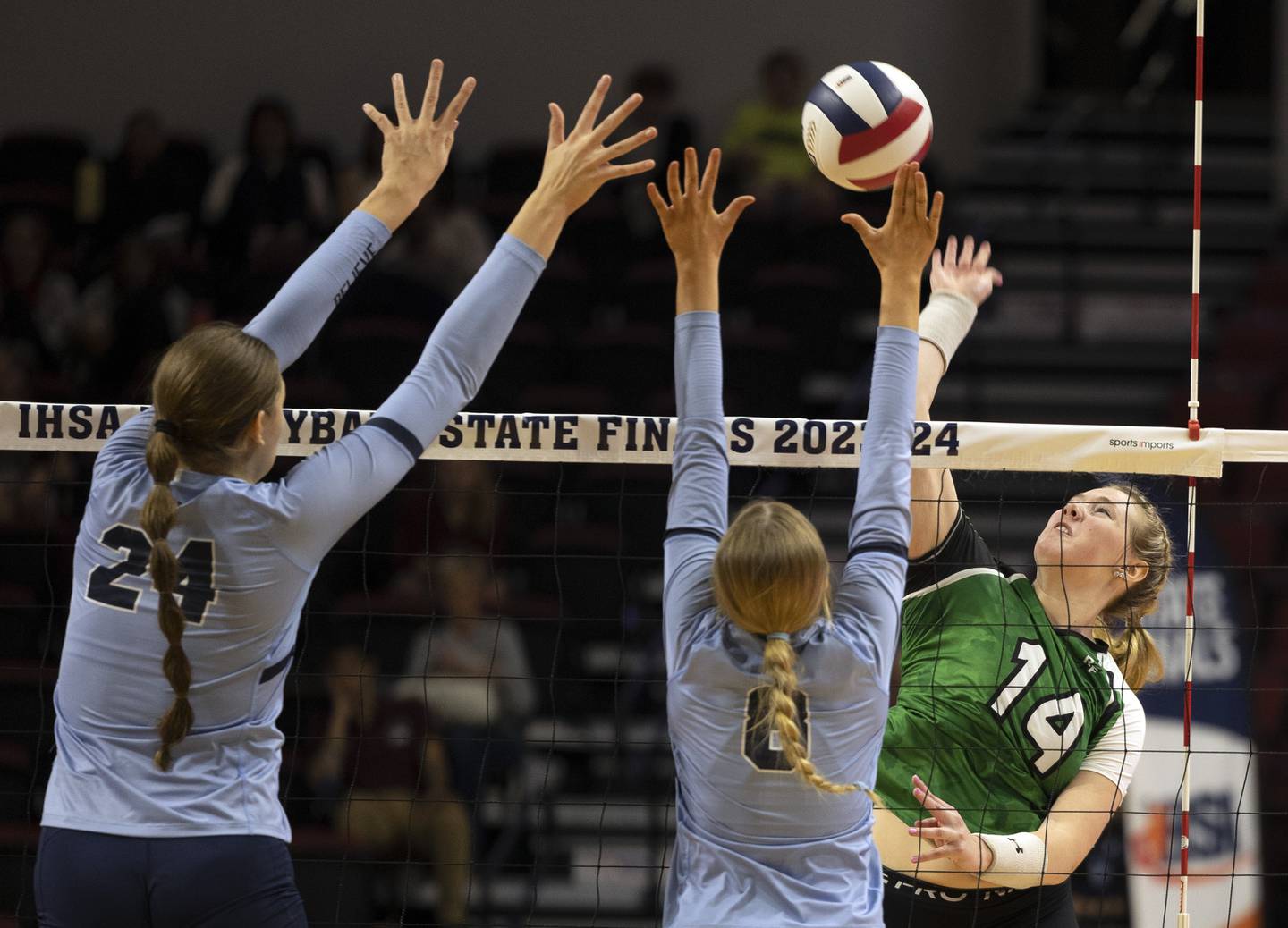 Rock Falls’ Nicolette Udell loads up for a hit against Breese Mater Dei’s Alyssa Koerkenmeier (left) and Addison Nenninger in the 2A state semifinal Friday, Nov. 10, 2023 at CEFCU Arena in Normal.