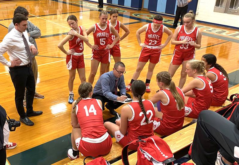Ottawa girls basketball coach Brent Moore (center) talks things over with his Pirates during a second-quarter timeout Tuesday, Nov. 15, 2022, in Fairbury.