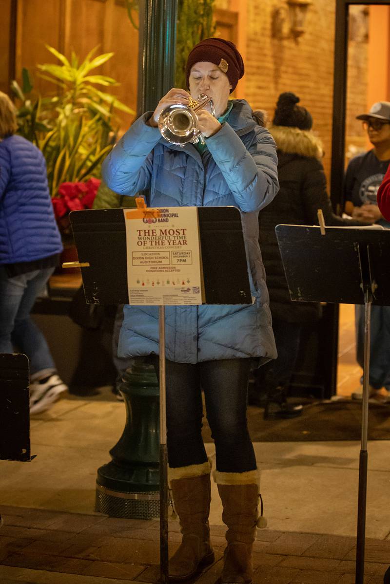 Sarah Habben of Dixon plays the trumpet for the Dixon Municipal Band during the Dixon Christmas walk Friday, Dec. 2, 2022.