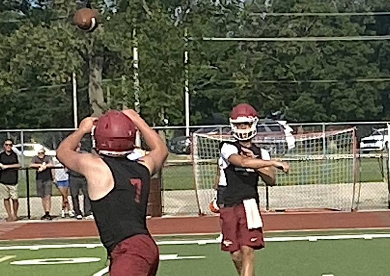 Morris' Griffin Zweeres (left) reaches up to grab a pass from teammate Brady Varner in a recent 7 on 7 competition at Morris.