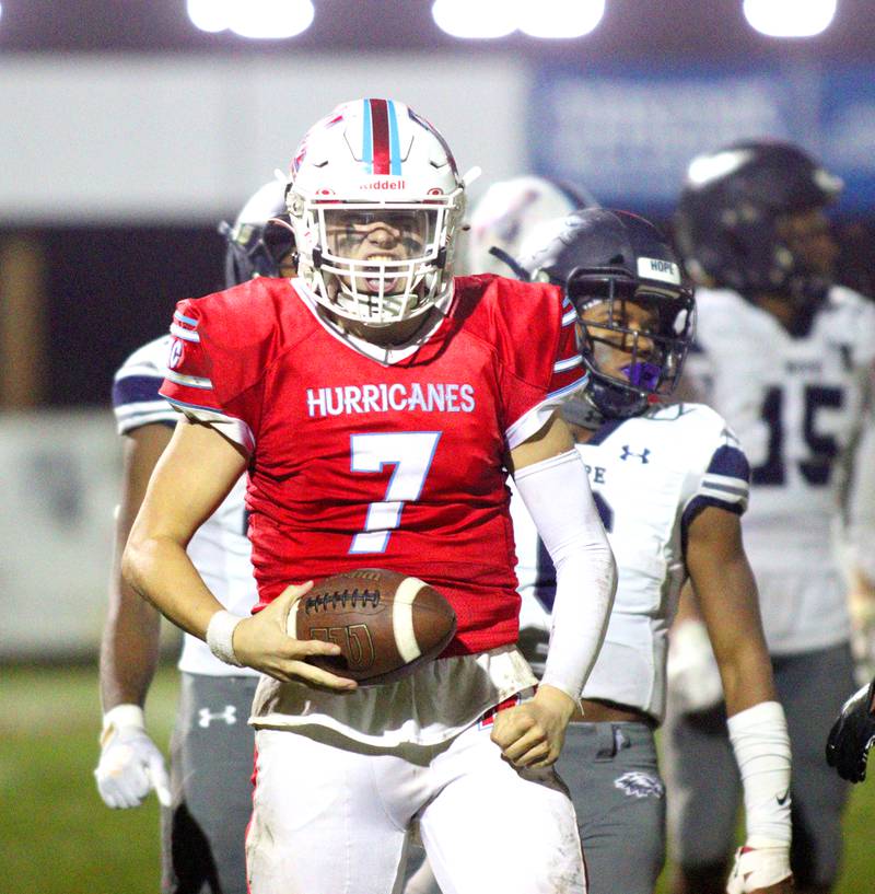 Marian Central’s Cale McThenia celebrates a first down against Chicago Hope in varsity  football  at Woodstock Friday night.