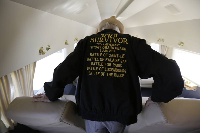 FILE - In this photo taken April 29, 2019, D-Day veteran Jake Larson walks to a seat before going for a ride in the "The Spirit of Benovia" WWII-era aircraft in Oakland, Calif. Both Larson and the former C-53 Skytrooper transport plane plan to be in Normandy, France and take part in events for the 75th anniversary of D-Day. (AP Photo/Eric Risberg, file)