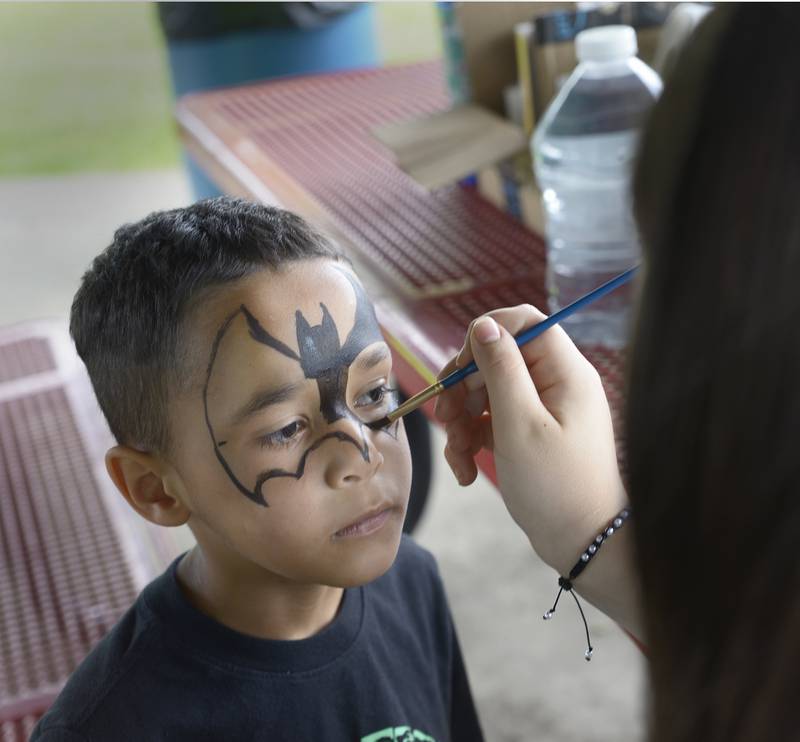ashawn Webber gets made up like Batman as he gets his face painted Saturday during Spring Valley’s Summerfest.