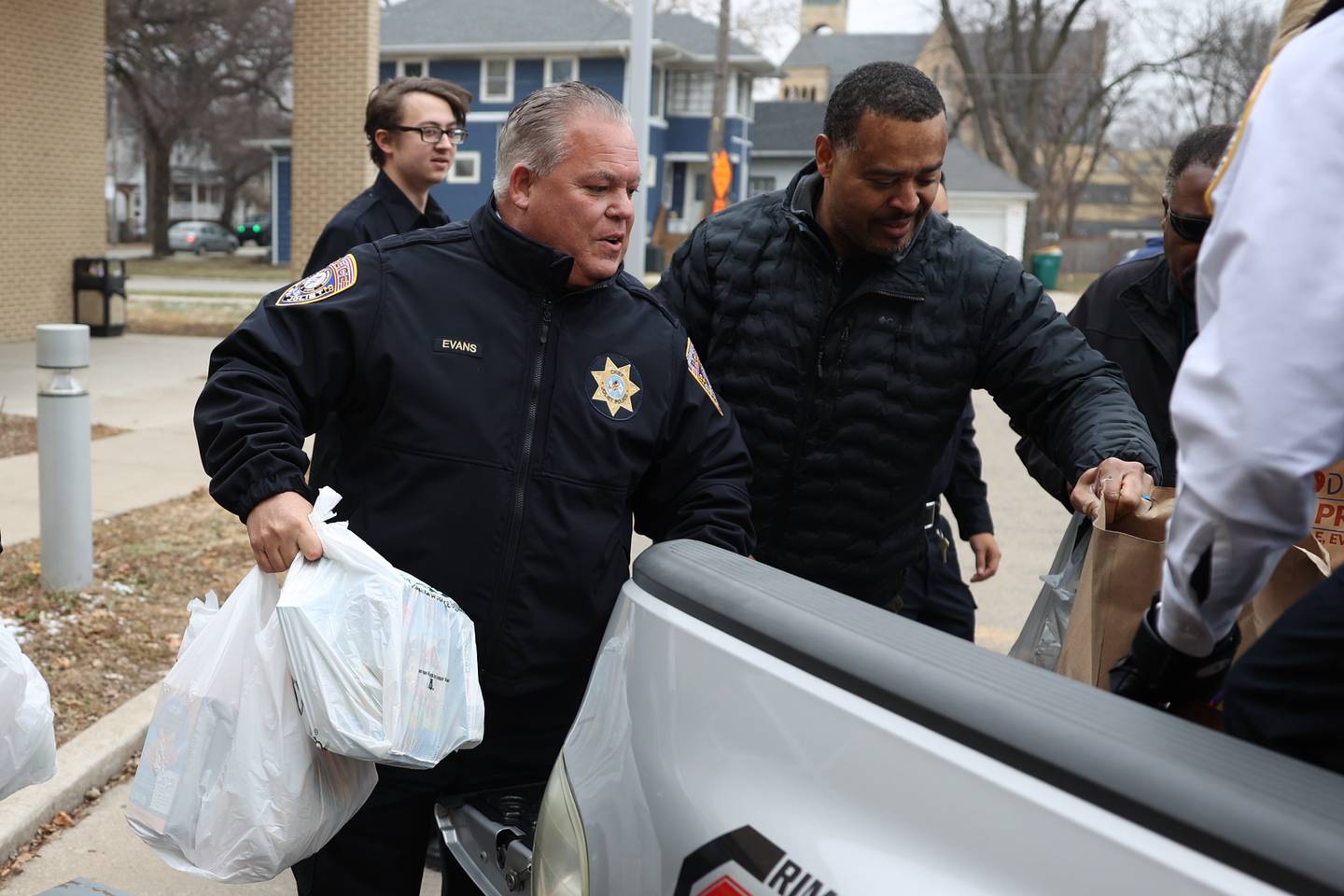 Joliet Police Chief Bob Evans and Deputy Richard Brown unload food donations from the police department’s “Pack the Paddy Wagon” food drive at the Salvation Army in Joliet.