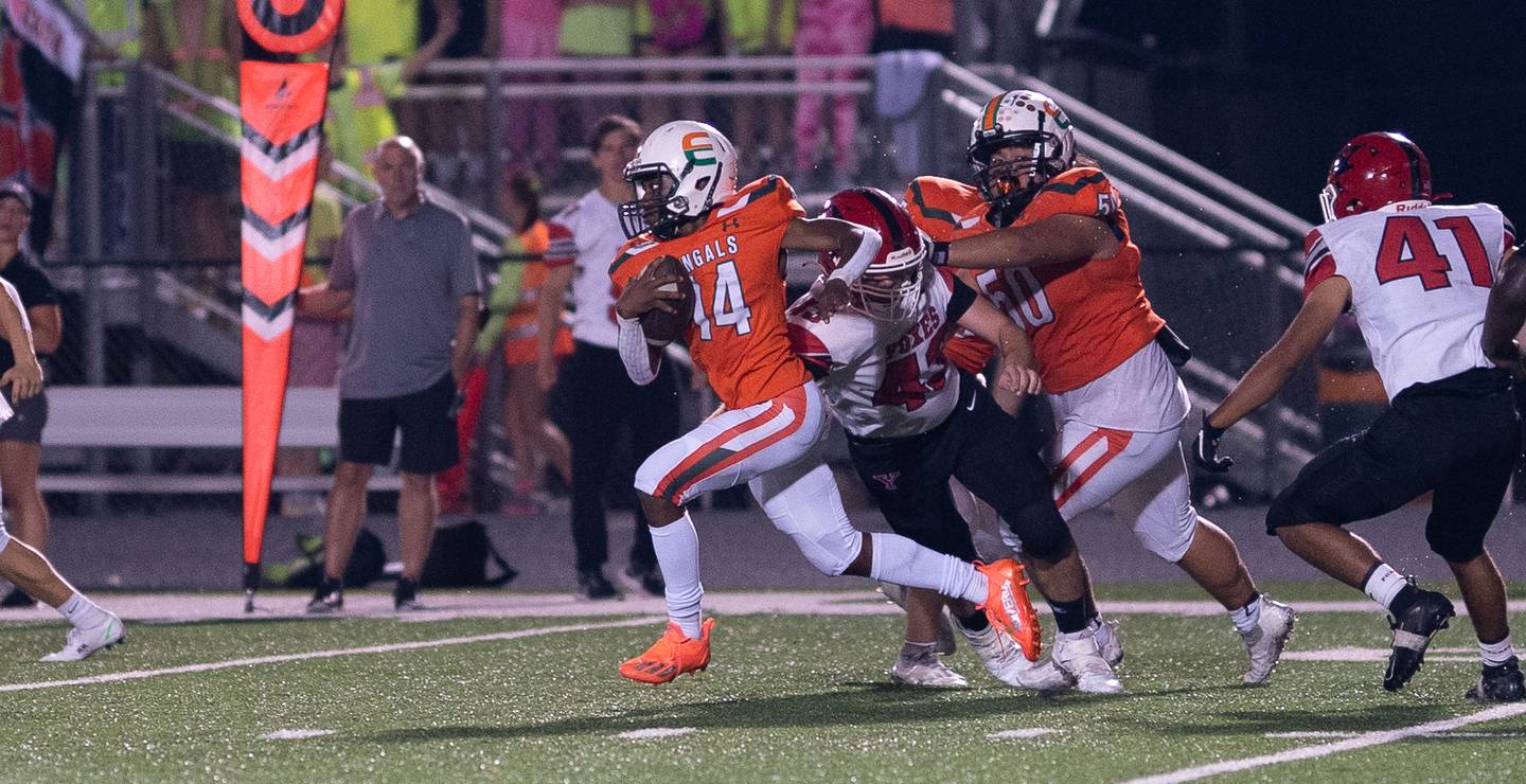Plainfield East's Armani McFerren (14) carries the ball against Yorkville during a high school football game at Plainfield East High School in Plainfield on Friday, Sep 17, 2021.