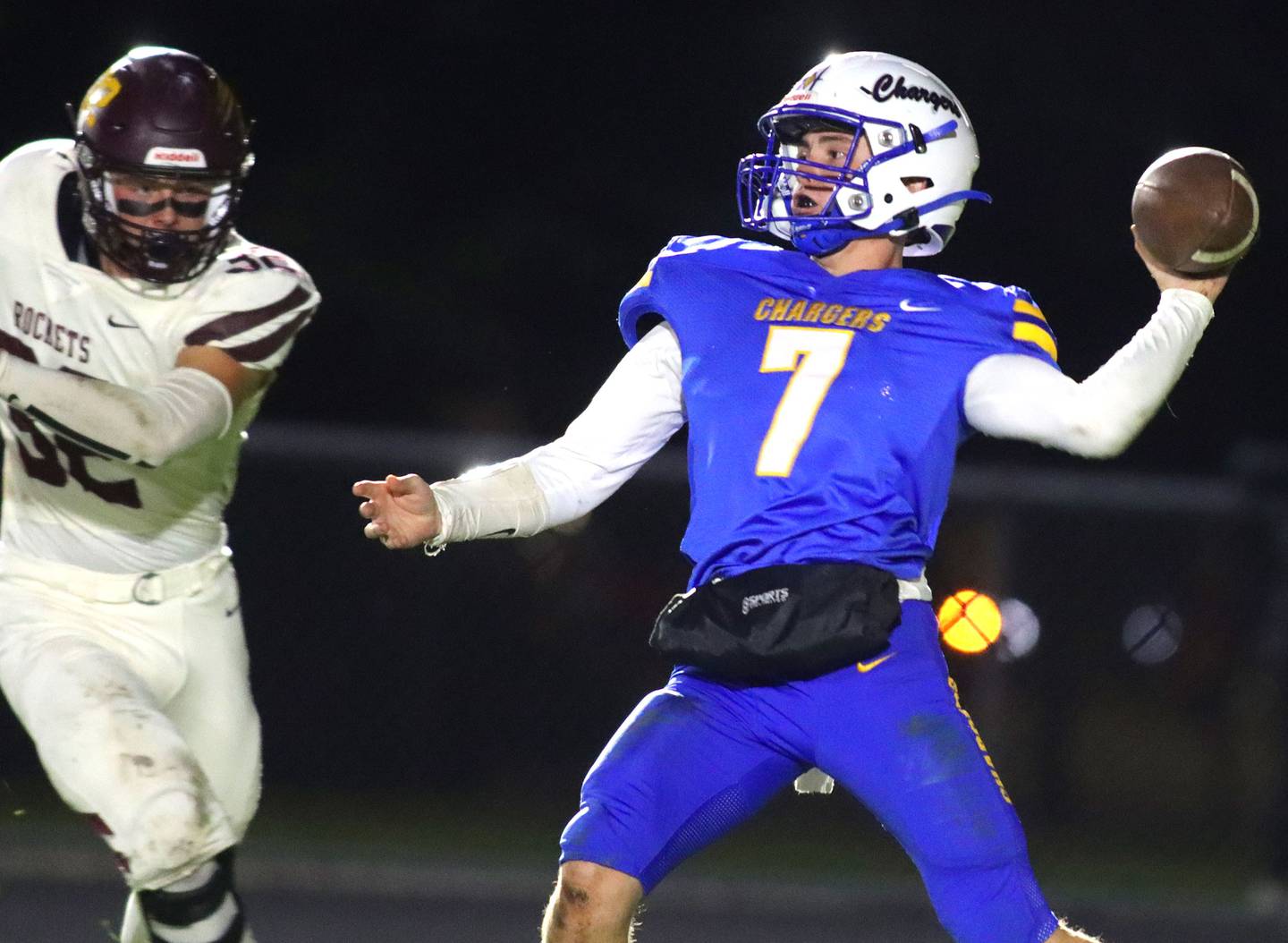 Richmond-Burton’s Breckin Campbell, left, closes in as Aurora Central Catholic’s Grant Bohr passes in IHSA football Class 3A second-round playoff action at Bob Stewart Field on the campus of Aurora Central Catholic High School in Aurora on Friday, November 7, 2025.