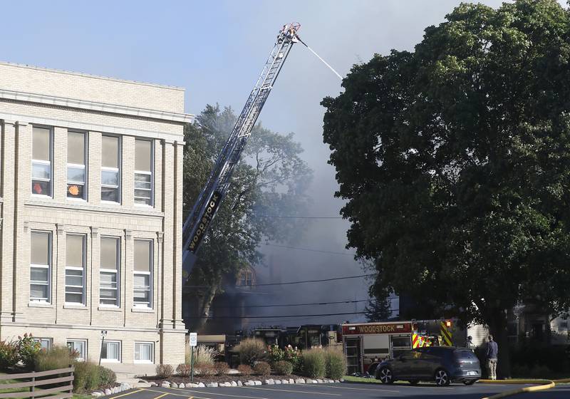 Firefighters battle a house fire in the 300 block of Lincoln Avenue in Woodstock Monday, Oct. 9, 2023, after an explosion following suspected gas leak in the area.