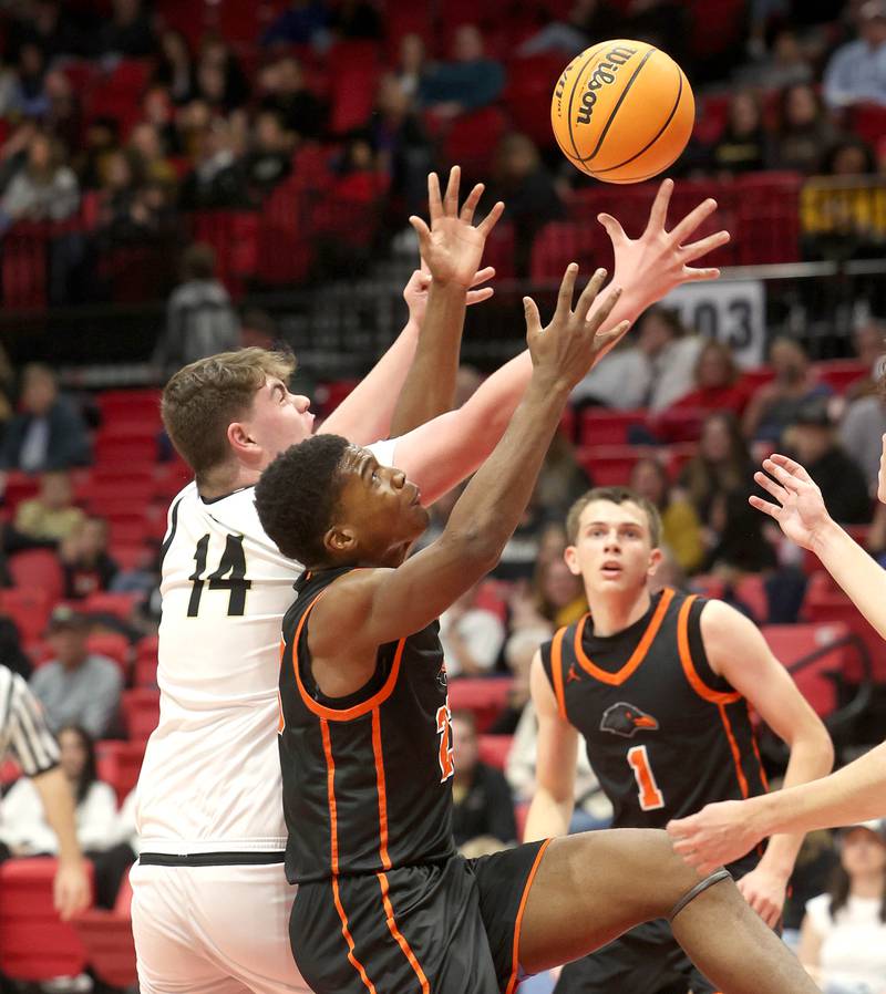 Sycamore's Michael Chami and DeKalb's Davon Grant go after a rebound during their game Friday, Jan. 31, 2025, in the FNBO Challenge in the Convocation Center at Northern Illinois University in DeKalb.