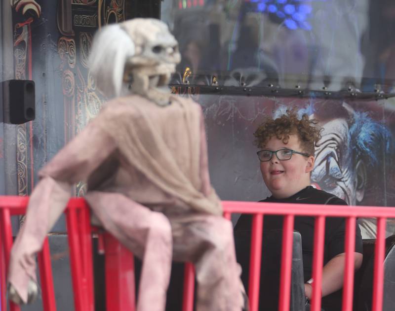 Bentley Bennett of La Salle, reacts after looking at a scary fake monkey while riding the Psycho Park ride during the Peru Mall Carnival on Monday, June 26, 2023.