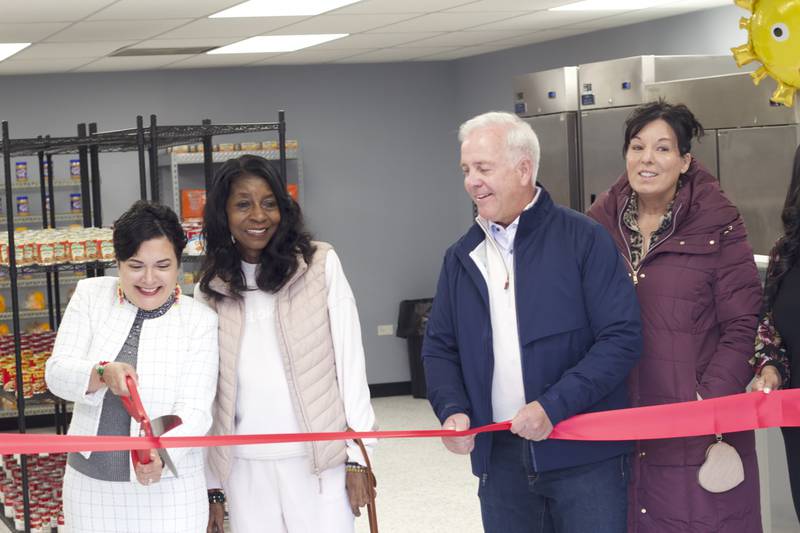 Joliet Township Supervisor Alicia Morales (left), cuts a red ribbon on Monday, April 21, 2025, for a ceremony recognizing the food pantry at the Joliet Township Forest Park Community Center. Standing next to Morales is Bettye Gavin, former executive director of the community center and Joliet City Council member, Joliet Mayor Terry D'Arcy, and Suzanna Ibarra, Joliet City Council member.