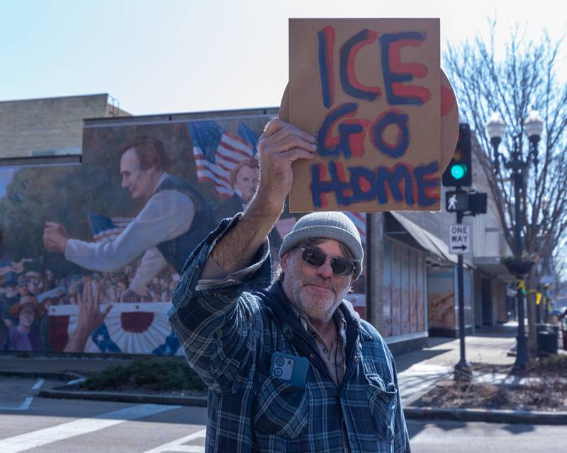 Protester holds sign at the 'Pretti good time for a Protest' on Feb. 15, 2026 at Washington Square Park in Ottawa.