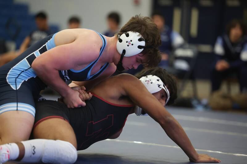 Plainfield South’s Colin Bickett works to roll Plainfield North’s Raphael Tovar in a Southwest Prairie dual meet on Wednesday, Nov. 29, 2023 in Plainfield.