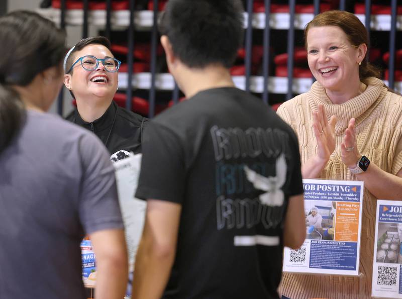 Maury Mattison (left) and Ashley Murcia, from the Suter Company, talk to attendees at their booth Thursday, April 23, 2026, during the DeKalb Chamber of Commerce Local Showcase in the Convocation Center at Northern Illinois University in DeKalb.