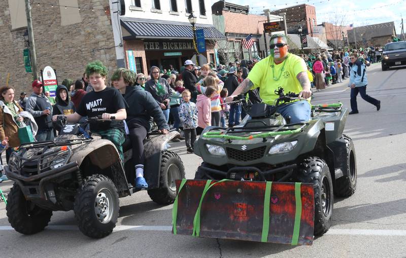 People ride four-wheelers during the St. Patrick's Day parade on Saturday, March 16, 2024 downtown Utica.