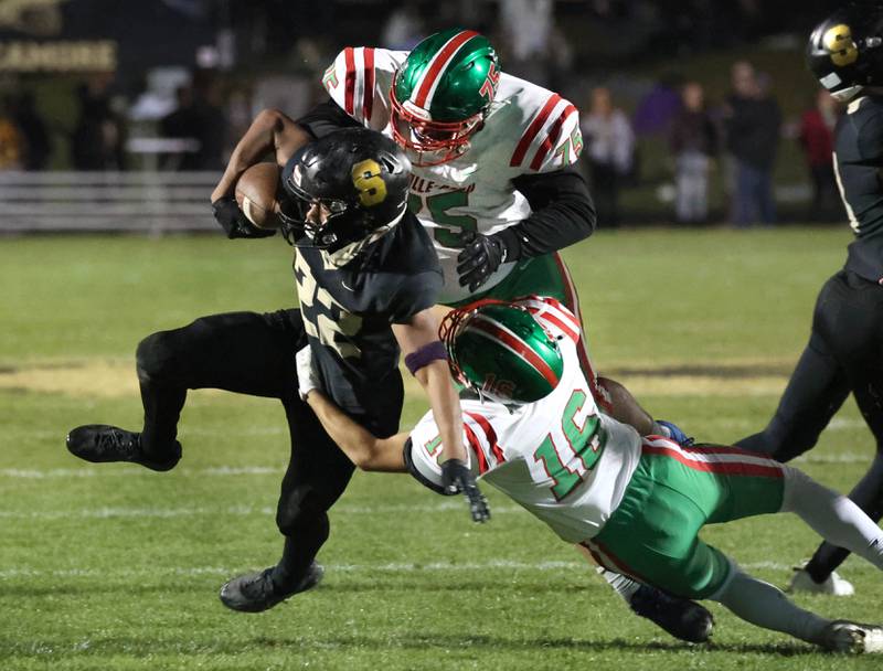La Salle-Peru’s Owen Mrowicki (left) and Evan Downey bring down Sycamore's Dylan Curtis during their game Friday, Oct. 10, 2025, at Sycamore High School.