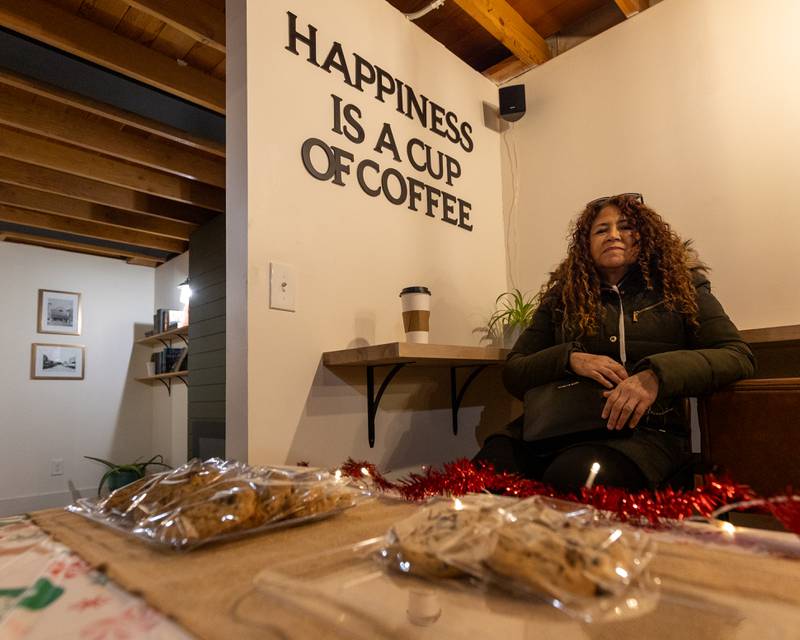 Customer sits behind tray of cookies on Sunday, December 14, 2025 at The Coffee Barn in Mendota.