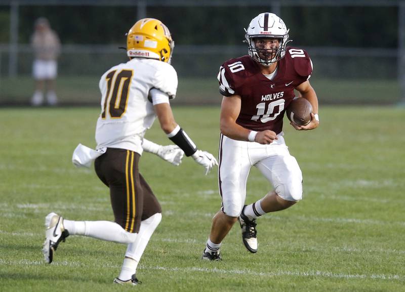 Prairie Ridge's Owen Satterlee runs with the ball as Jacobs' Jayden Gaona closes in during a Fox Valley Conference football game on Friday, Sept. 5, 2025, at Prairie Ridge High School in Crystal Lake.