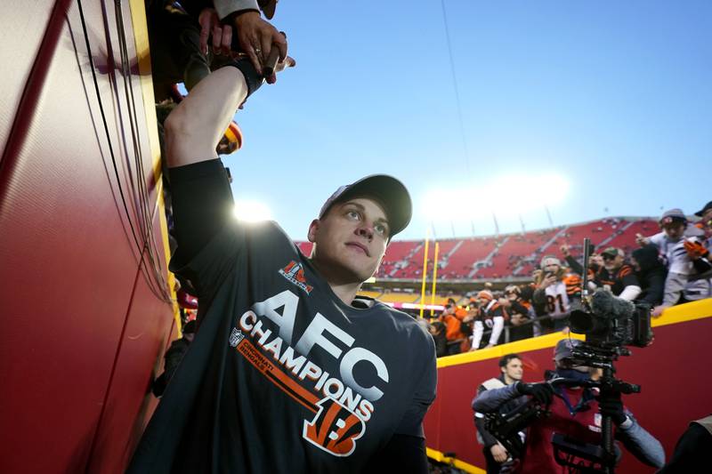Cincinnati Bengals quarterback Joe Burrow celebrates with fans after the AFC championship NFL football game against the Kansas City Chiefs, Sunday, Jan. 30, 2022, in Kansas City, Mo. The Bengals won 27-24 in overtime. (AP Photo/Paul Sancya)