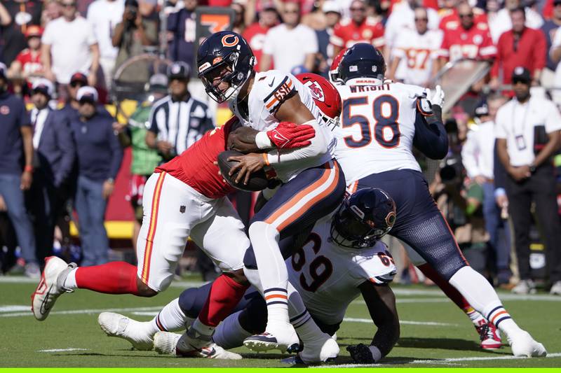 Chicago Bears quarterback Justin Fields is wrapped up by Kansas City Chiefs defensive end Mike Danna during the first half, Sunday, Sept. 24, 2023, in Kansas City, Mo.