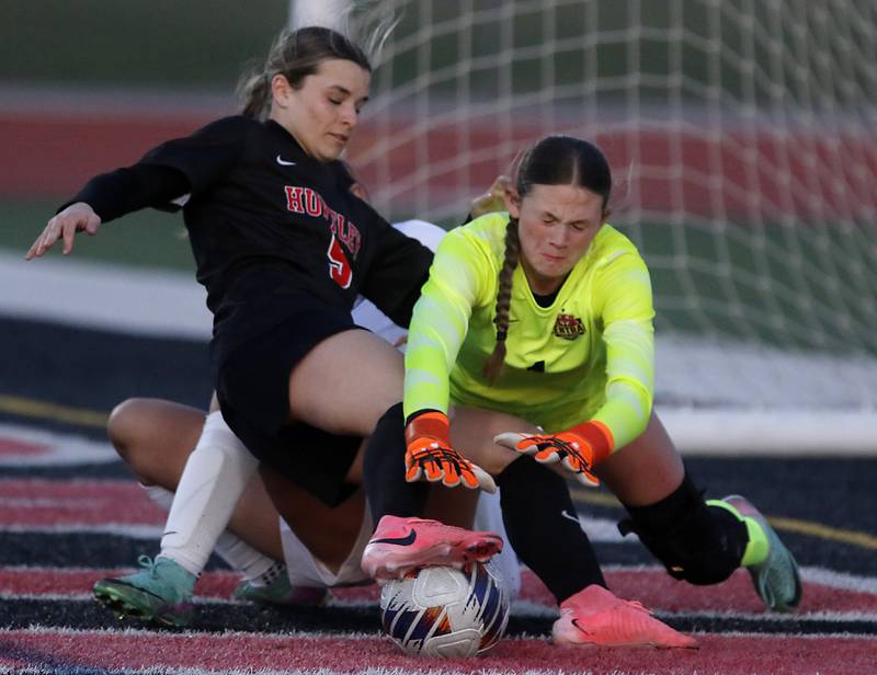 Crystal Lake Central's Kira Stavropoulos (left) and goalkeeper Crystal Ryleigh Smith (right) dives for the ball as Huntley's Maizie Nickle (center) tries to take a shot on goal during a Fox Valley Conference  soccer match on Tuesday, April 15, 2025, at Huntley High School.