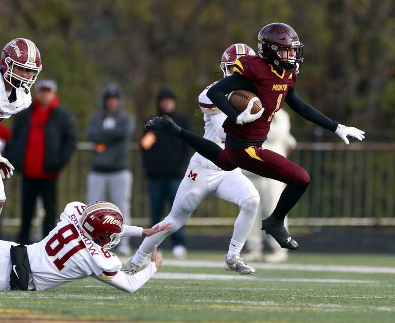 Montini's Luca Florio (1) avoids the grasp of Morris' Grant Sparrow (81) during the IHSA Class 4A semifinals football playoff game Saturday, Nov. 22, 2025 in Lombard.