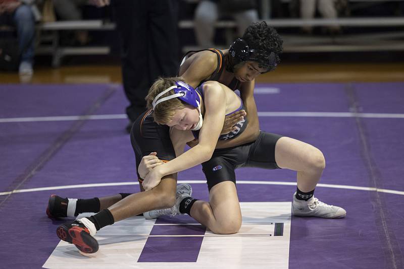 Dixon’s Ryan Rill grabs the leg of Freeport’s Yehezqel Nyatangi Tuesday, Jan. 13, 2025, during a triangular meet with Sterling.