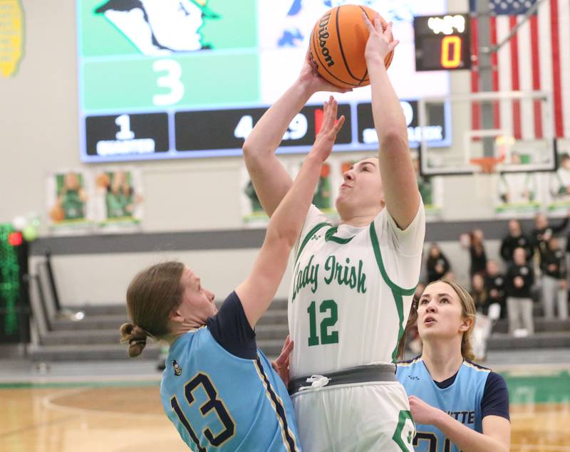 Seneca's Elsa Douglas shoots a jump shot over Marquette's Emily Ryan-Adair and Kaitlyn Davis on Thursday, Feb. 5, 2026 at Seneca High School.