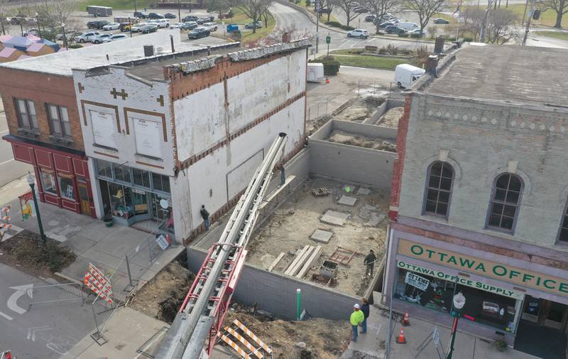 Crews prepare to pour the foundation of a new building at 205-207 W. Main St on Friday, Dec. 8, 2023 downtown Ottawa. The city had to close off Main Street in order to complete the pour.