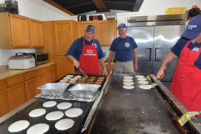 Mt. Morris Fire Chief Rob Hough and fellow firefighter Jeff Warren were two members of the Mt. Morris Fire Department who made breakfast for a large crowd on Tuesday during the department's annual Pancake and Sausage Breakfast at the fire station held during Let Freedom Ring.