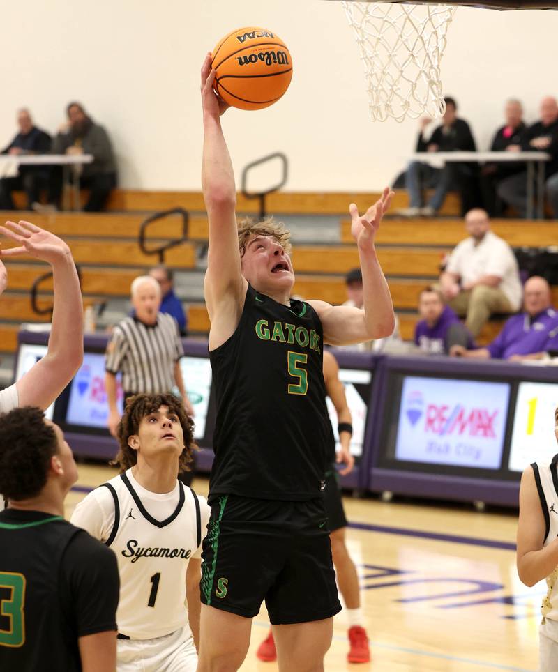 Crystal Lake South's Carson Trivellini scores in front of Sycamore's Josiah Mitchell during their sectional semifinal game Tuesday, March 4, 2025, at Rochelle High School.