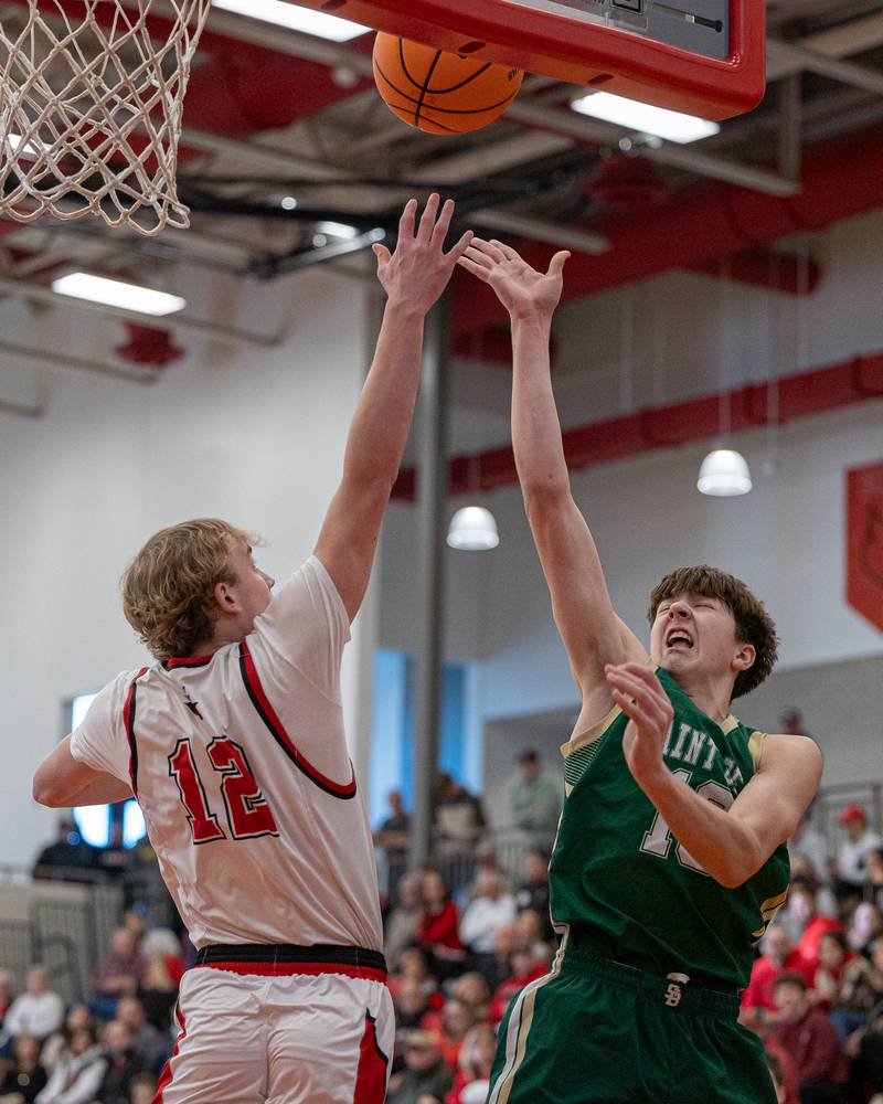 Hall's Clayton Fusinetti (21) leaps in attempt to contest shot from St. Bede's Graham Ross (13) on Saturday, January 31, 2026 at Hall High School in Spring Valley.